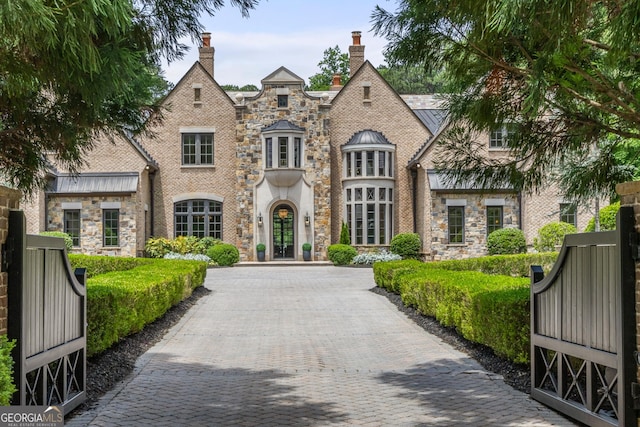 4560 Harris Trl, Atlanta, GA 30327 - english style home with french doors, a chimney, and stone siding