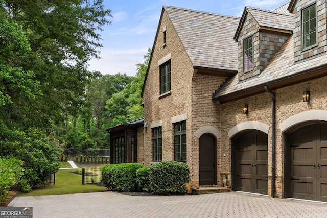 4560 Harris Trl, Atlanta, GA 30327 - view of patio / terrace featuring decorative driveway and a garage