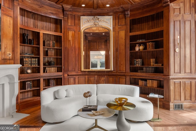 4560 Harris Trl, Atlanta, GA 30327 - living area with wooden walls, built in features, and wood finished floors