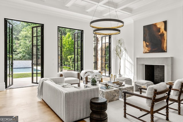 4560 Harris Trl, Atlanta, GA 30327 - living area featuring beam ceiling, coffered ceiling, wood finished floors, ornamental molding, and a fireplace