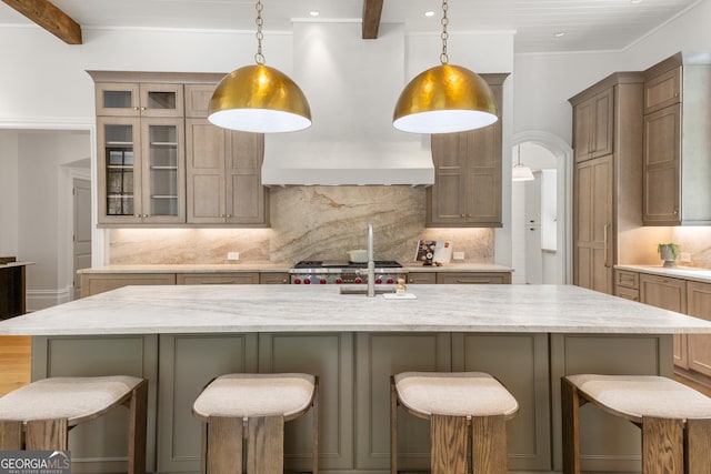 4560 Harris Trl, Atlanta, GA 30327 - kitchen with custom range hood, backsplash, glass insert cabinets, light stone countertops, and recessed lighting