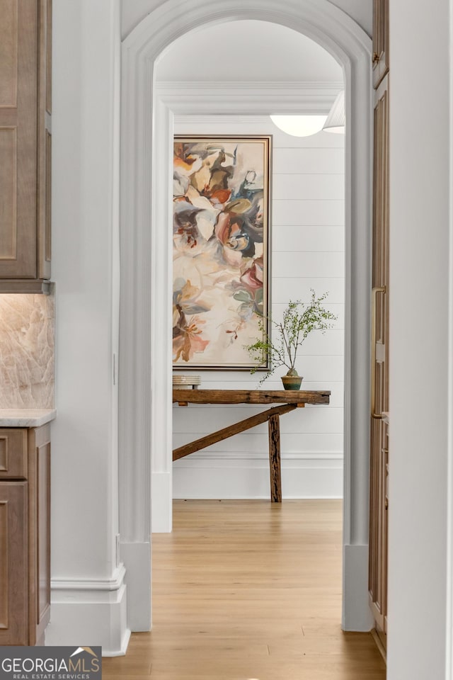 4560 Harris Trl, Atlanta, GA 30327 - hallway with light wood-style flooring, arched walkways, and baseboards