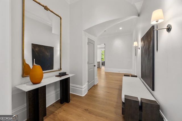 4560 Harris Trl, Atlanta, GA 30327 - hallway featuring ornamental molding, light wood-style flooring, arched walkways, baseboards, and recessed lighting