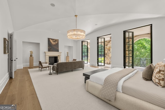 4560 Harris Trl, Atlanta, GA 30327 - bedroom featuring wood finished floors, multiple windows, access to outside, and a chandelier