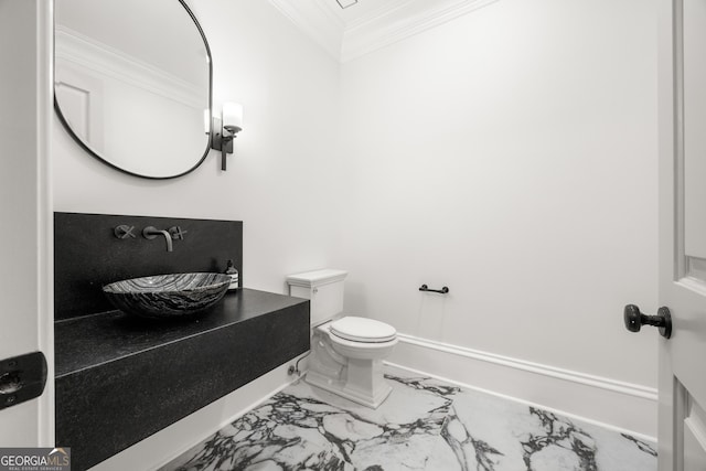 4560 Harris Trl, Atlanta, GA 30327 - bathroom featuring ornamental molding, a sink, marble finish floors, and toilet