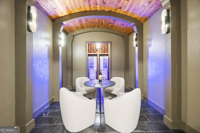 4560 Harris Trl, Atlanta, GA 30327 - dining space featuring baseboards, wood ceiling, arched walkways, lofted ceiling, and a textured wall