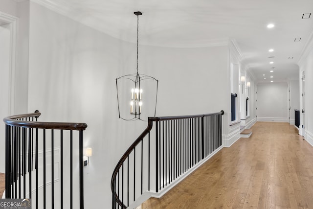 4560 Harris Trl, Atlanta, GA 30327 - corridor featuring an upstairs landing, ornamental molding, recessed lighting, wood finished floors, and a chandelier