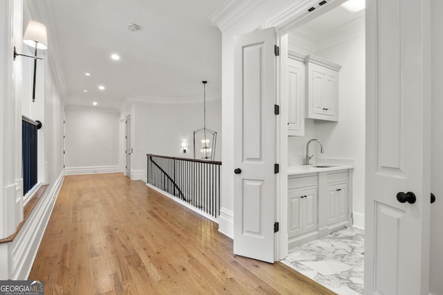 4560 Harris Trl, Atlanta, GA 30327 - corridor with a sink, crown molding, a chandelier, recessed lighting, and baseboards