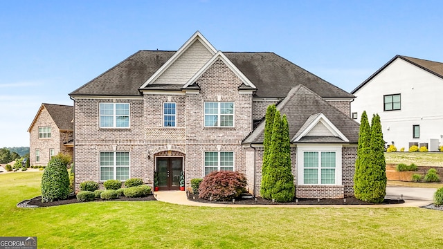 1516 Winward Dr, Locust Grove, GA 30248 - view of front facade featuring brick siding, french doors, and a front yard