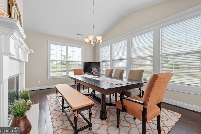 1516 Winward Dr, Locust Grove, GA 30248 - dining space with vaulted ceiling, wood-type flooring, a chandelier, baseboards, and a fireplace