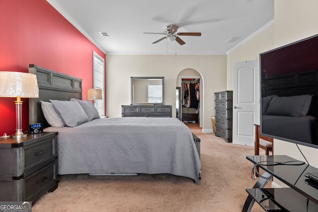 1516 Winward Dr, Locust Grove, GA 30248 - bedroom with crown molding, light colored carpet, arched walkways, a ceiling fan, and a closet