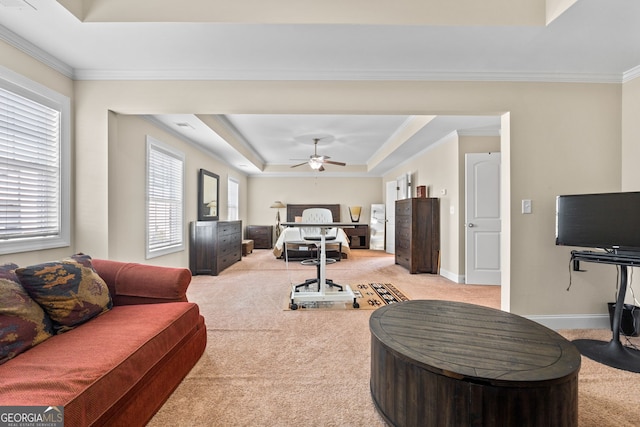1516 Winward Dr, Locust Grove, GA 30248 - living area featuring light carpet, a raised ceiling, a ceiling fan, crown molding, and baseboards