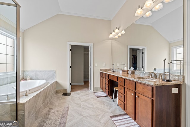 1516 Winward Dr, Locust Grove, GA 30248 - bathroom featuring double vanity, a walk in closet, lofted ceiling, a garden tub, and ornamental molding