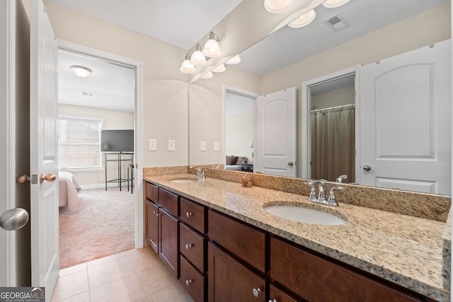 1516 Winward Dr, Locust Grove, GA 30248 - ensuite bathroom featuring double vanity, tile patterned flooring, and baseboards