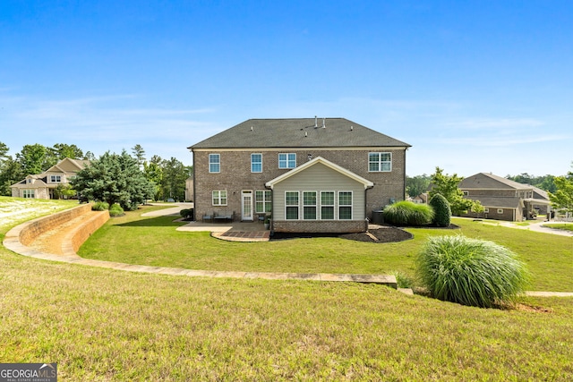 1516 Winward Dr, Locust Grove, GA 30248 - rear view of property featuring brick siding, a yard, and a patio