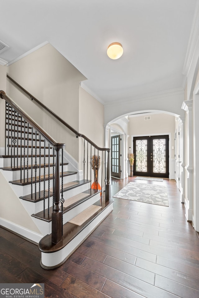 1516 Winward Dr, Locust Grove, GA 30248 - entrance foyer with arched walkways, ornamental molding, ornate columns, french doors, and hardwood / wood-style floors