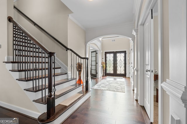 1516 Winward Dr, Locust Grove, GA 30248 - entrance foyer with arched walkways, french doors, dark wood-style flooring, crown molding, and stairs