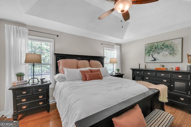 2006 Carrollton Hwy, Temple, GA 30179 - bedroom featuring wood finished floors, multiple windows, a textured ceiling, and ceiling fan