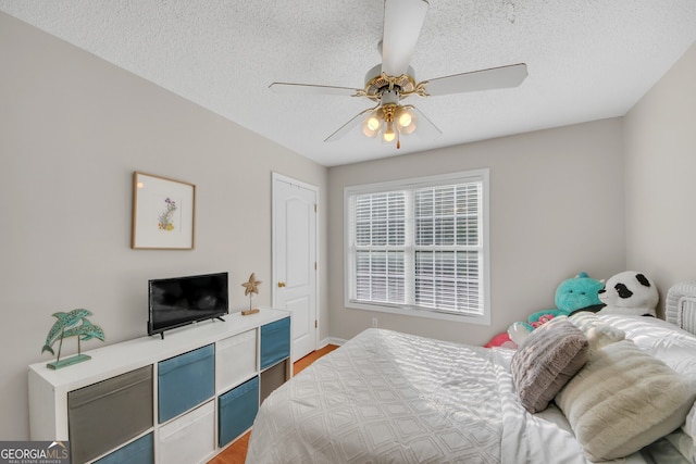 2006 Carrollton Hwy, Temple, GA 30179 - bedroom with light wood-style flooring, a textured ceiling, ceiling fan, and baseboards