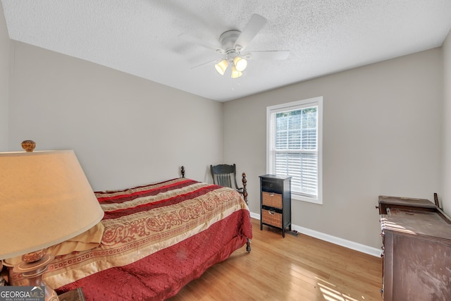 2006 Carrollton Hwy, Temple, GA 30179 - bedroom featuring wood finished floors, baseboards, a textured ceiling, and a ceiling fan