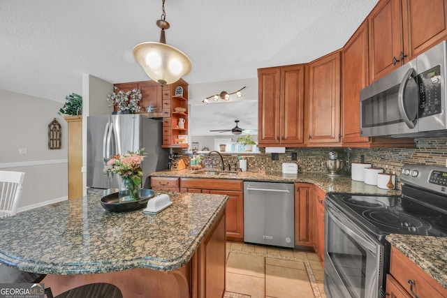 2006 Carrollton Hwy, Temple, GA 30179 - kitchen featuring appliances with stainless steel finishes, a sink, tasteful backsplash, brown cabinets, and ceiling fan