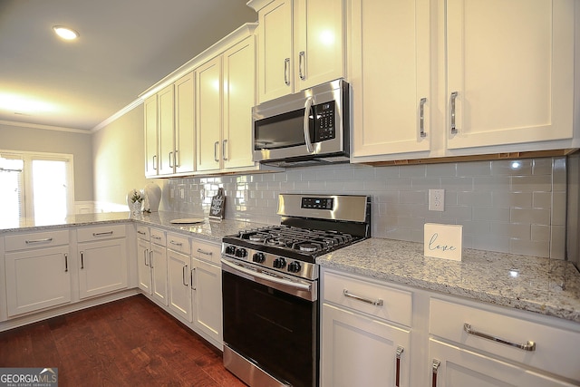 2304 Shetley Creek Dr, Norcross, GA 30071 - kitchen with stainless steel appliances, ornamental molding, dark wood-style floors, decorative backsplash, and light stone counters