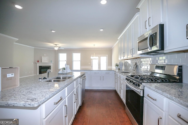 2304 Shetley Creek Dr, Norcross, GA 30071 - kitchen with appliances with stainless steel finishes, a sink, a ceiling fan, crown molding, and white cabinetry