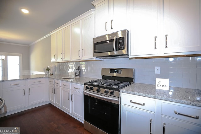 2304 Shetley Creek Dr, Norcross, GA 30071 - kitchen featuring appliances with stainless steel finishes, crown molding, white cabinetry, light stone countertops, and dark wood-style floors