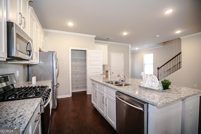 2304 Shetley Creek Dr, Norcross, GA 30071 - kitchen with stainless steel appliances, a sink, a kitchen island with sink, crown molding, and white cabinetry