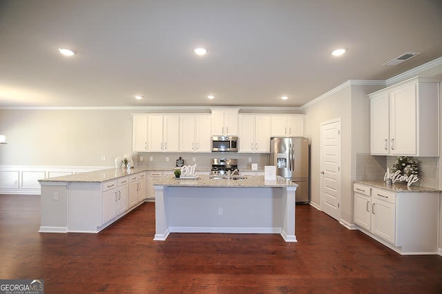 2304 Shetley Creek Dr, Norcross, GA 30071 - kitchen featuring stainless steel appliances, a peninsula, decorative backsplash, ornamental molding, and light stone counters