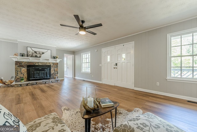 130 April Trce, Dawsonville, GA 30534 - living room featuring ceiling fan, wood finished floors, baseboards, crown molding, and a textured ceiling