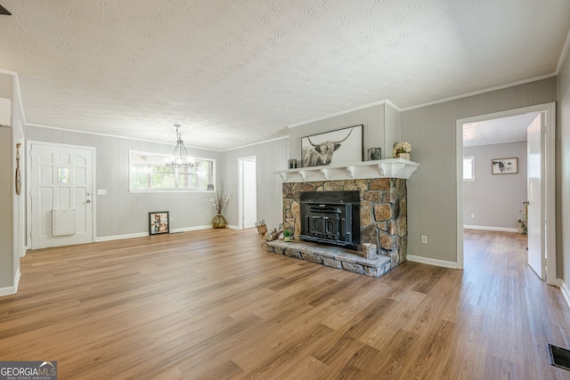 130 April Trce, Dawsonville, GA 30534 - unfurnished living room featuring healthy amount of natural light, a chandelier, a textured ceiling, wood finished floors, and ornamental molding