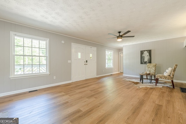130 April Trce, Dawsonville, GA 30534 - foyer with light wood-type flooring, a textured ceiling, ceiling fan, baseboards, and crown molding