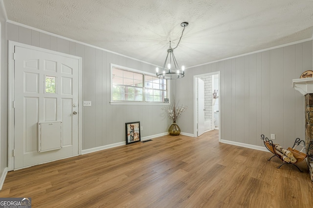 130 April Trce, Dawsonville, GA 30534 - unfurnished dining area featuring a chandelier, crown molding, light wood finished floors, baseboards, and a textured ceiling