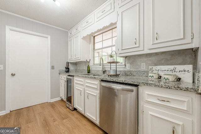 130 April Trce, Dawsonville, GA 30534 - kitchen featuring stainless steel dishwasher, ornamental molding, beverage cooler, light wood finished floors, and white cabinets