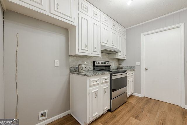 130 April Trce, Dawsonville, GA 30534 - kitchen with stainless steel range with electric stovetop, under cabinet range hood, light wood-style flooring, white cabinets, and ornamental molding