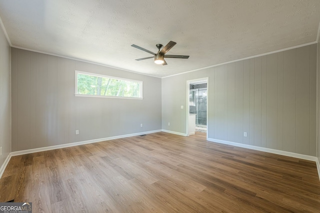 130 April Trce, Dawsonville, GA 30534 - empty room with a textured ceiling, wood finished floors, a ceiling fan, baseboards, and crown molding