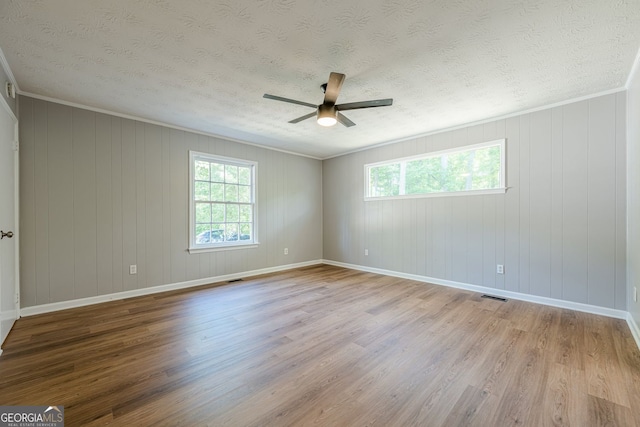 130 April Trce, Dawsonville, GA 30534 - empty room with healthy amount of natural light, wood finished floors, a textured ceiling, ceiling fan, and crown molding