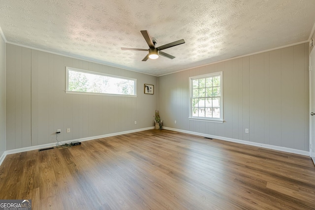 130 April Trce, Dawsonville, GA 30534 - unfurnished room featuring plenty of natural light, ceiling fan, a textured ceiling, and wood finished floors