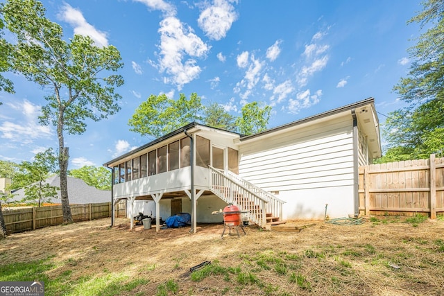 130 April Trce, Dawsonville, GA 30534 - back of property featuring a sunroom, a fenced backyard, and stairs