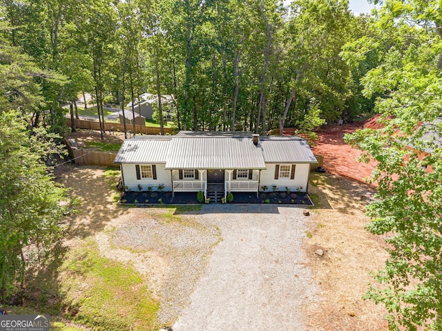 130 April Trce, Dawsonville, GA 30534 - view of front facade featuring covered porch, gravel driveway, and metal roof