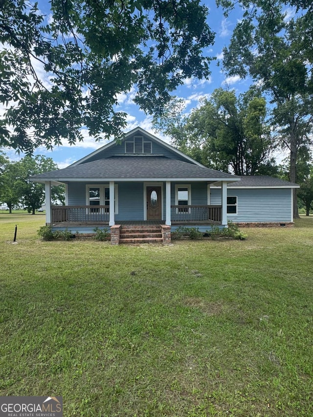 3 Thurman Dasher Rd, Reidsville, GA 30453 - view of front of home with roof with shingles, covered porch, and a front lawn
