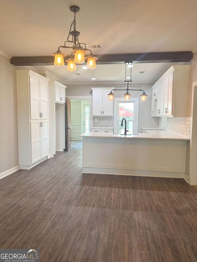 3 Thurman Dasher Rd, Reidsville, GA 30453 - kitchen with dark wood-type flooring, white cabinets, a peninsula, beamed ceiling, and light countertops