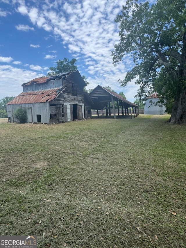 3 Thurman Dasher Rd, Reidsville, GA 30453 - view of green lawn featuring a barn and an outbuilding