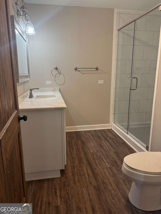 3 Thurman Dasher Rd, Reidsville, GA 30453 - full bathroom with vanity, a shower stall, baseboards, wood finished floors, and toilet