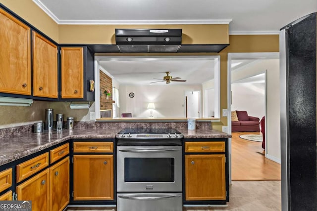 8415 Ridge Rd, Fairburn, GA 30213 - kitchen featuring appliances with stainless steel finishes, ceiling fan, ornamental molding, dark countertops, and brown cabinetry