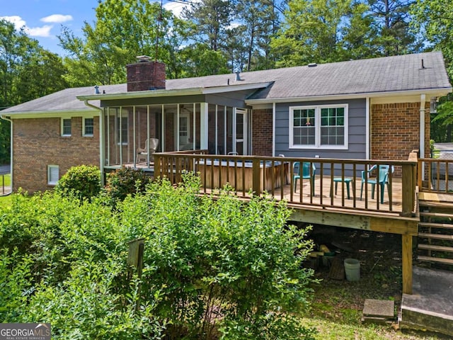 8415 Ridge Rd, Fairburn, GA 30213 - back of house with a sunroom, a wooden deck, brick siding, and a chimney