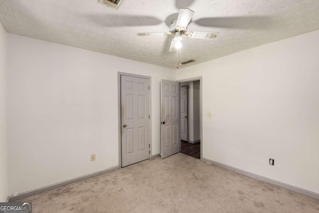 2617 Laurel Woods Ln SE, Conyers, GA 30094 - unfurnished bedroom featuring carpet, baseboards, a textured ceiling, and ceiling fan