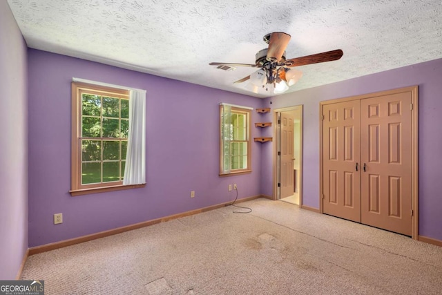 2617 Laurel Woods Ln SE, Conyers, GA 30094 - unfurnished bedroom featuring carpet flooring, baseboards, a ceiling fan, and a textured ceiling