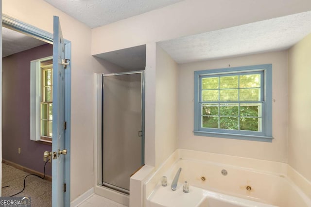2617 Laurel Woods Ln SE, Conyers, GA 30094 - full bathroom featuring a shower stall, a tub with jets, a textured ceiling, and baseboards